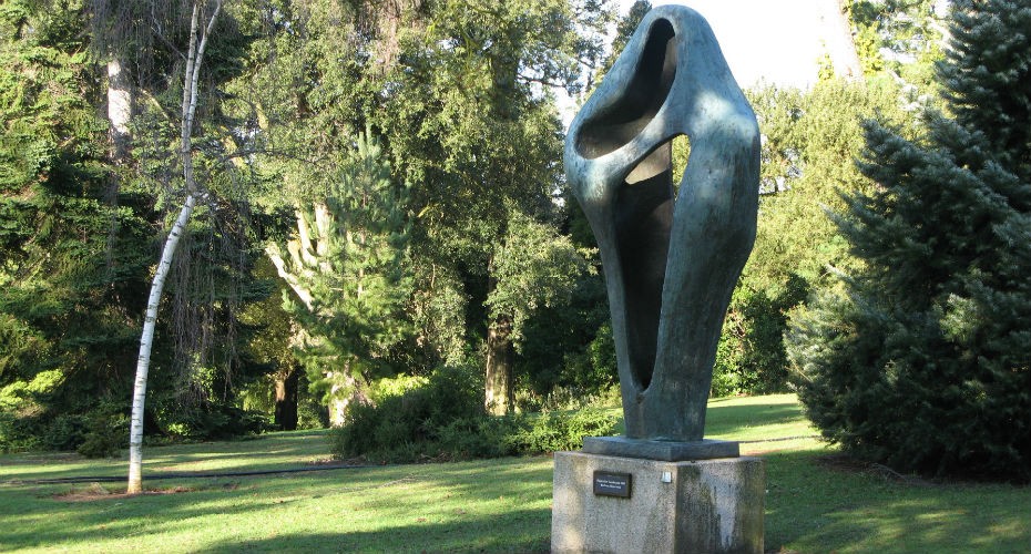 A large green tree sculpture titled 
