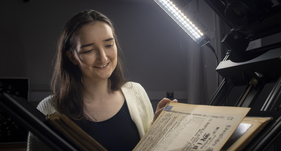Student viewing a historical book