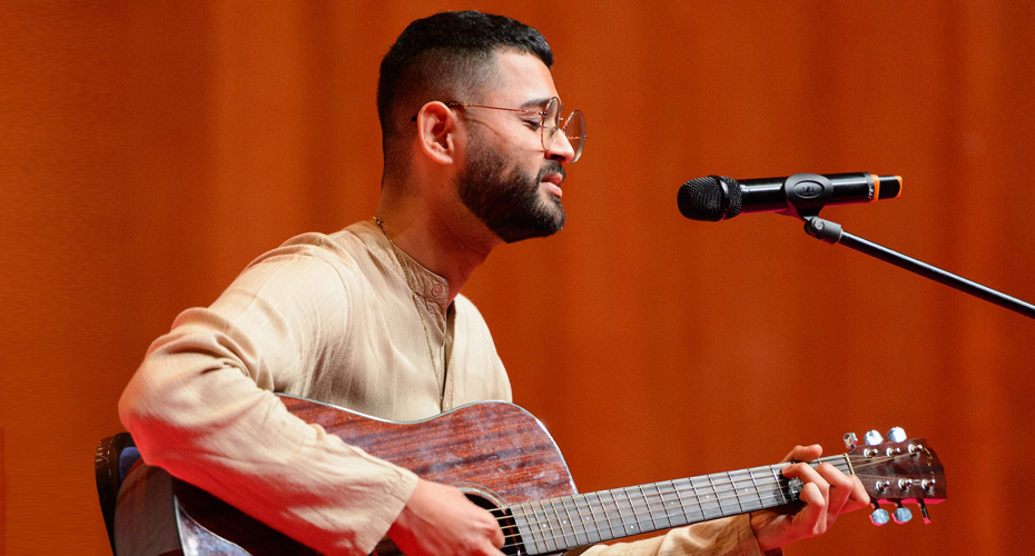 A student performing on guitar